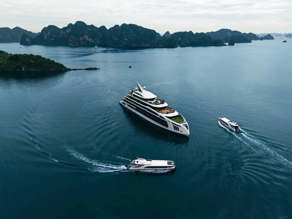 Celina of the Sea under way in Lan Ha Bay, seen from above, with two tender boats