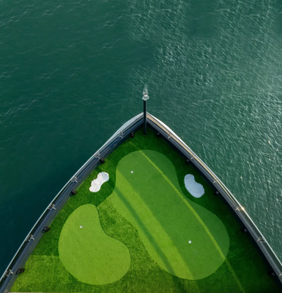 The bow of Tulip Cruise seen from above, with a mini golf green on deck