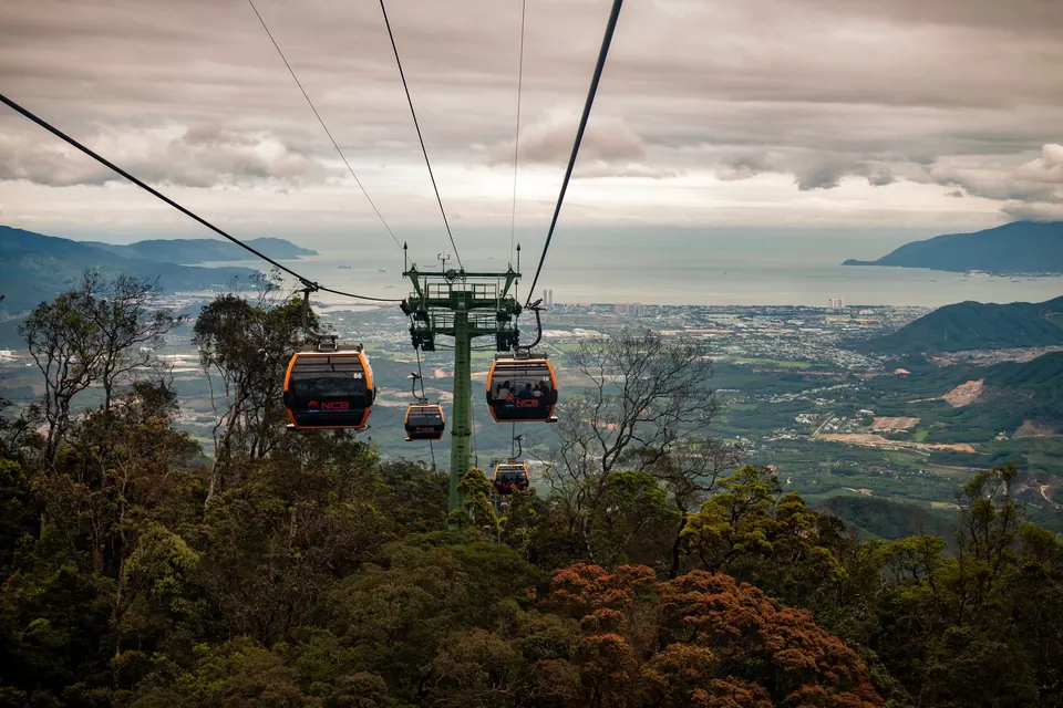 Cable car gondolas crossing to Cat Ba island at sunset