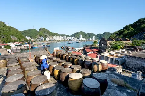 Clay jars drying on a harbour roof in Cat Ba town