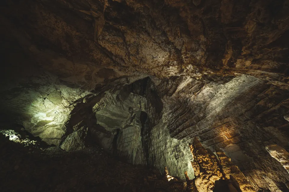 Inside Hospital Cave on Cat Ba, rock walls lit in low light