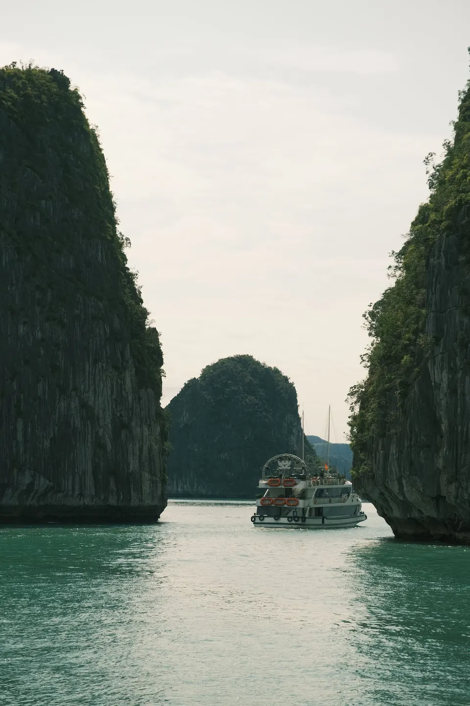 A small boat passing between two karst towers