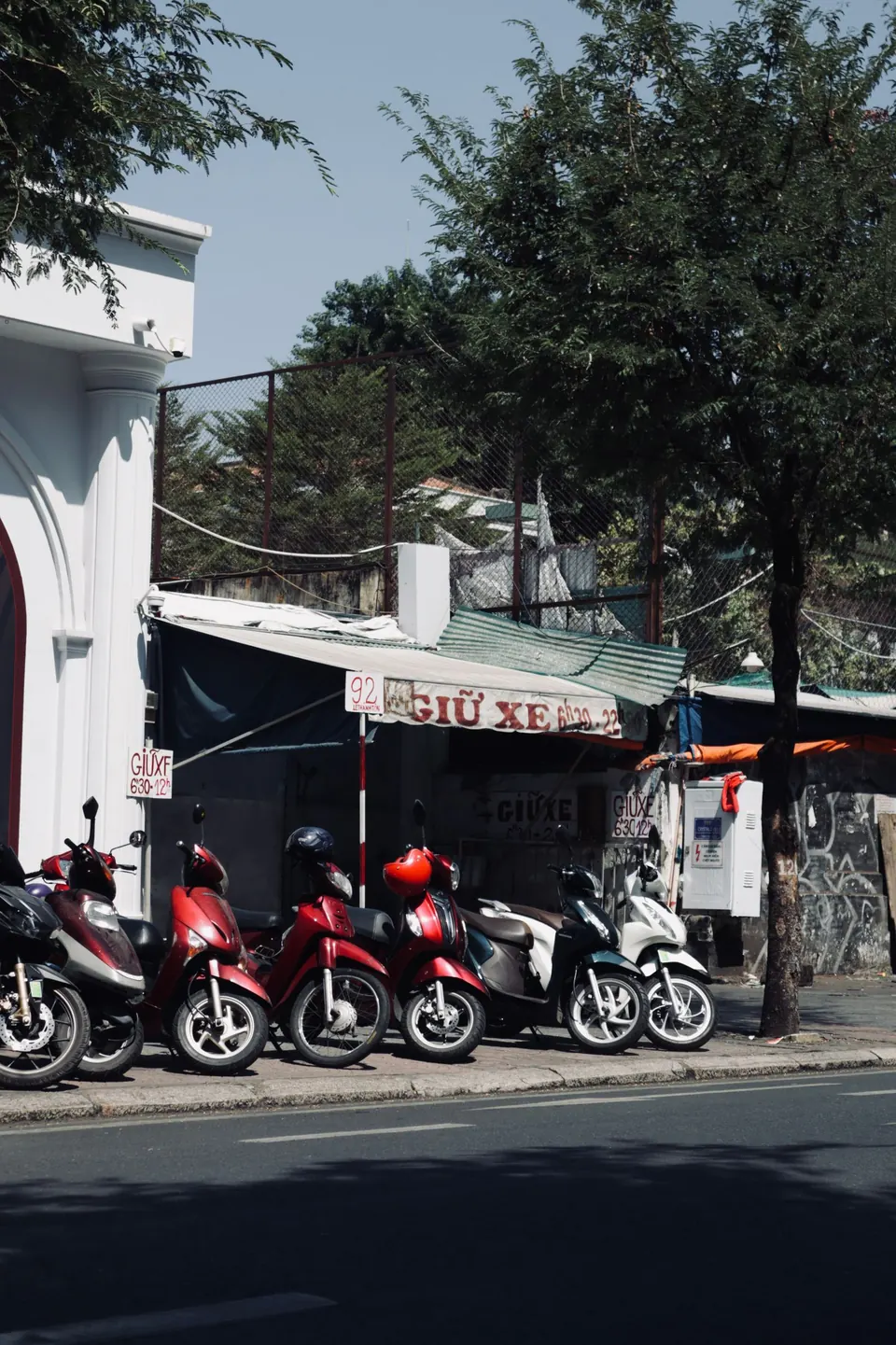 Rental motorbikes parked on a street in Cat Ba town